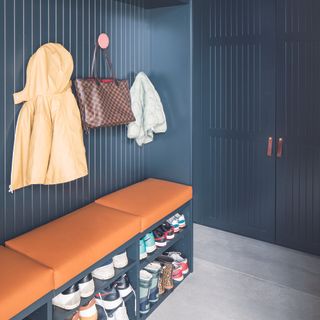 Hallway storage with navy wall panelling