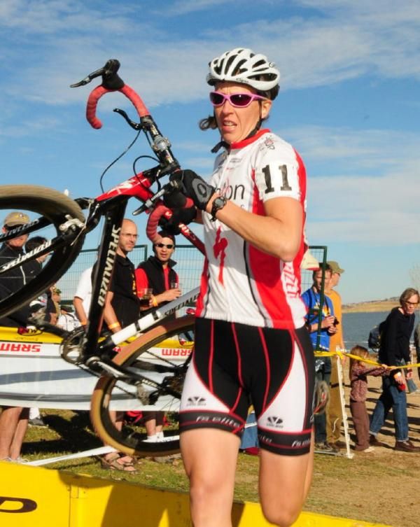 Lora Heckman (Peloton Cycles) over the barriers.