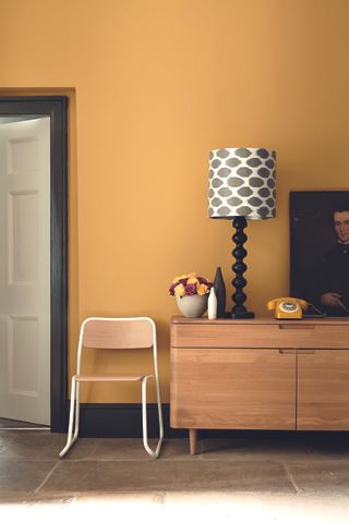 A warm sunny yellow entryway in mid century style