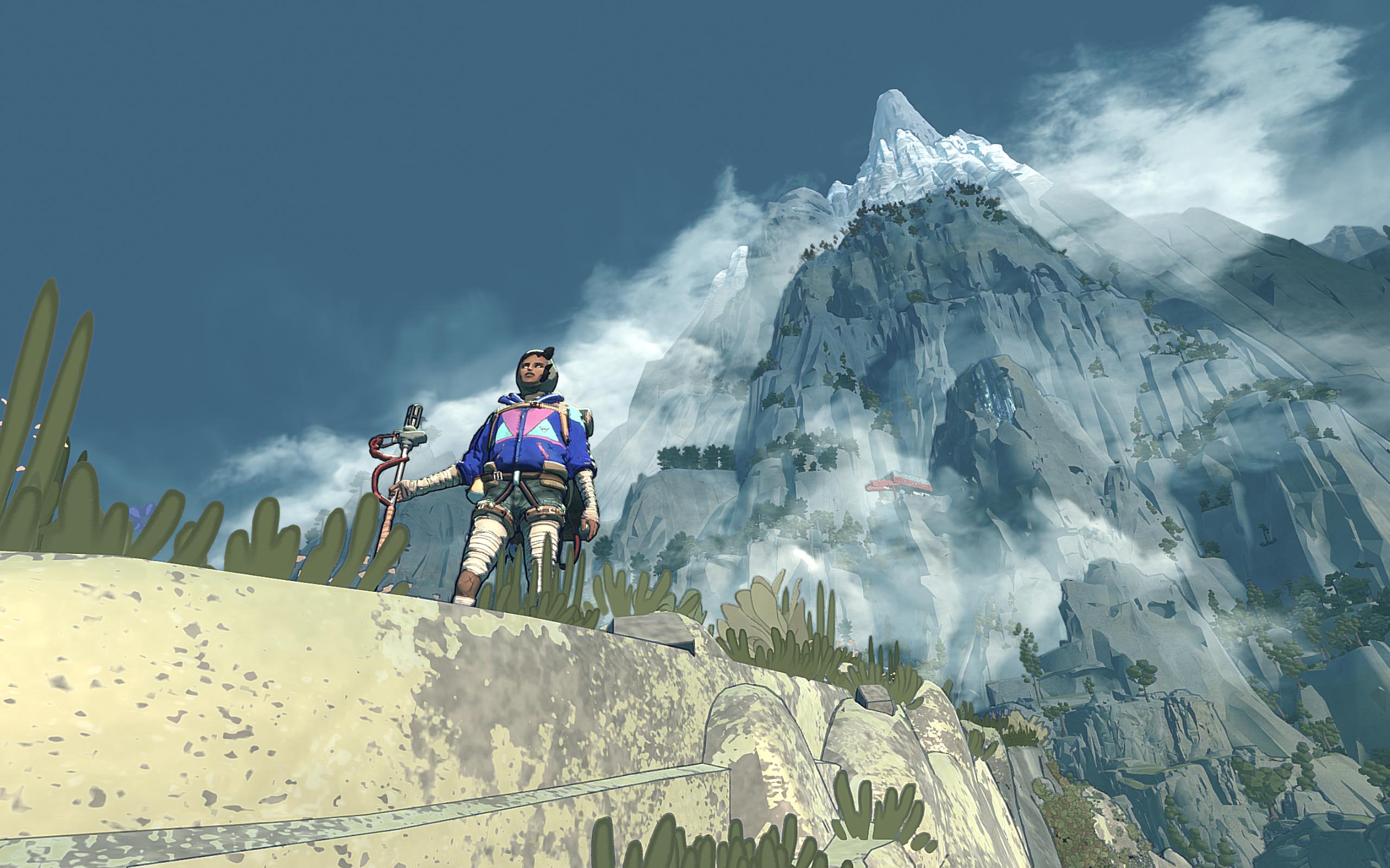 A woman stands on a landing with a huge mountain behind her