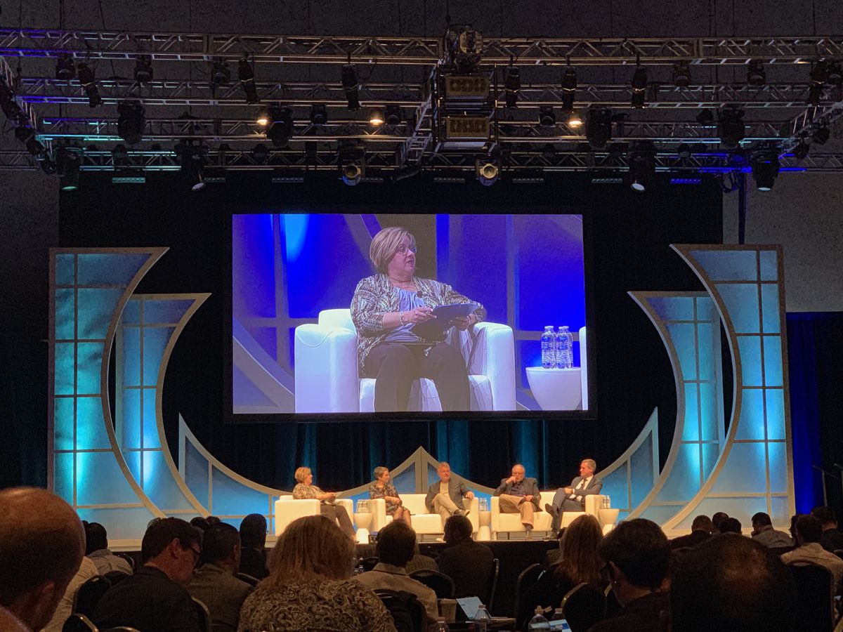 Camille Burch moderates a digital signage panel at AVEC 2019.