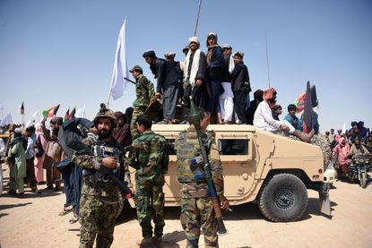 Afghan Taliban members celebrate cease-fire in June 2018.