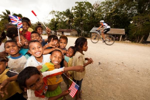 Youngsters cheer on a passing rider