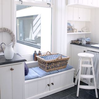 utility room with white cabinets