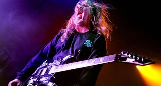 Jeff Hanneman screams as he plays his Heineken/Hanneman graphic ESP signature guitar onstage with Slayer