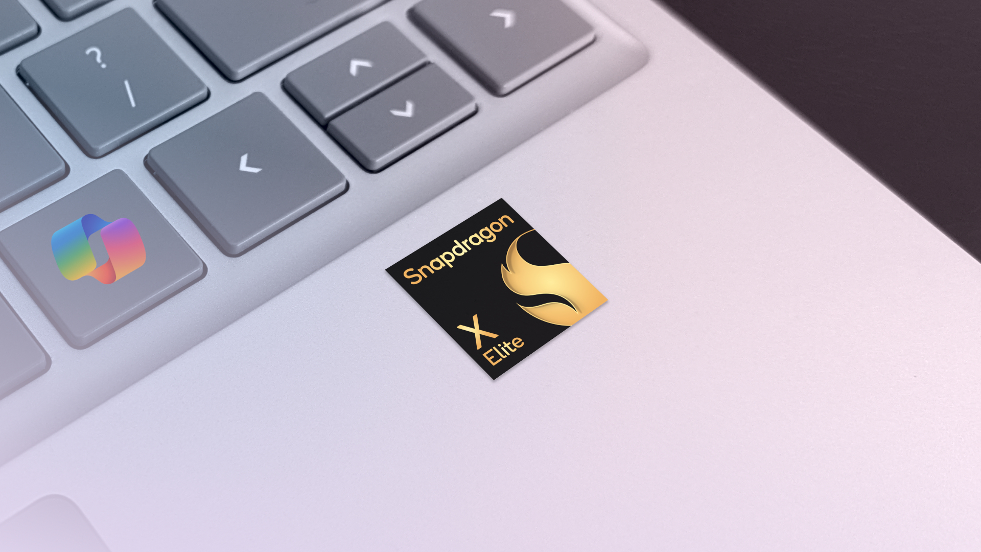 Qualcomm Snapdragon X Elite sticker on a Microsoft Surface Laptop deck with Copilot key.