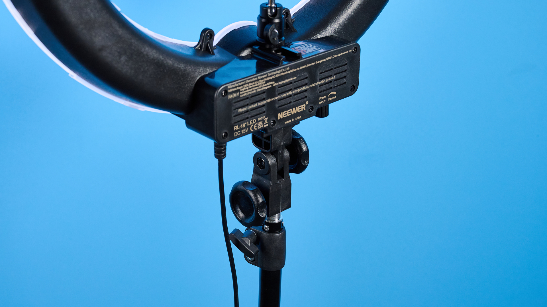 Neewer RL-18 ring light photographed in front of a blue background.