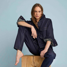 Model sat with leg up on a stool wearing a Lindex denim outfit