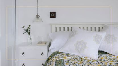 white bedroom with a white wooden bed frame white bedside table with a green and yellow bedspread