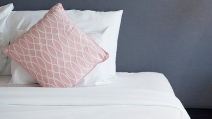Bed room with white bed and pink pillow