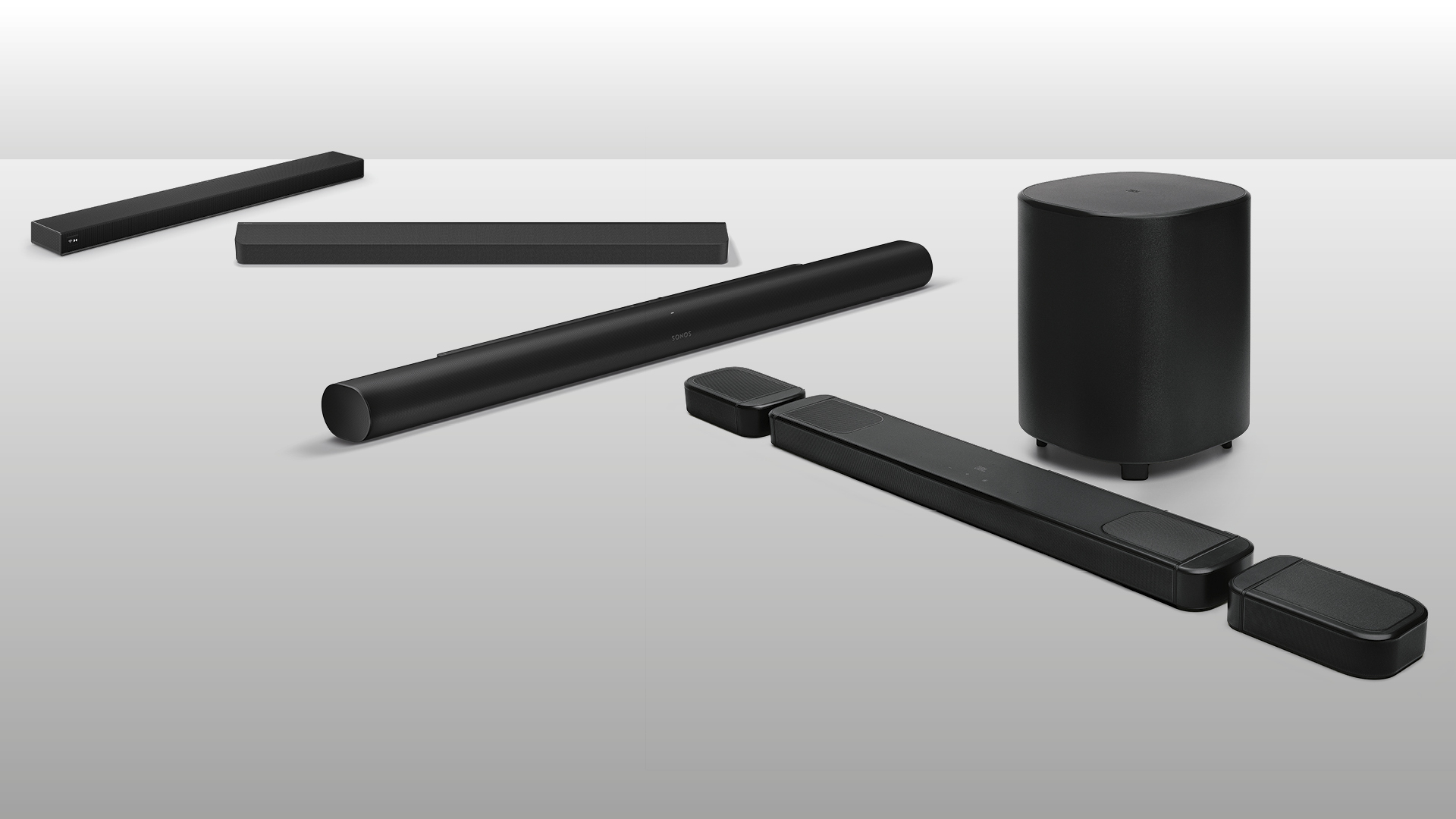 Four black soundbars arranged against a grey background