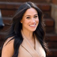 Meghan Markle wearing a sleeveless trench coat dress