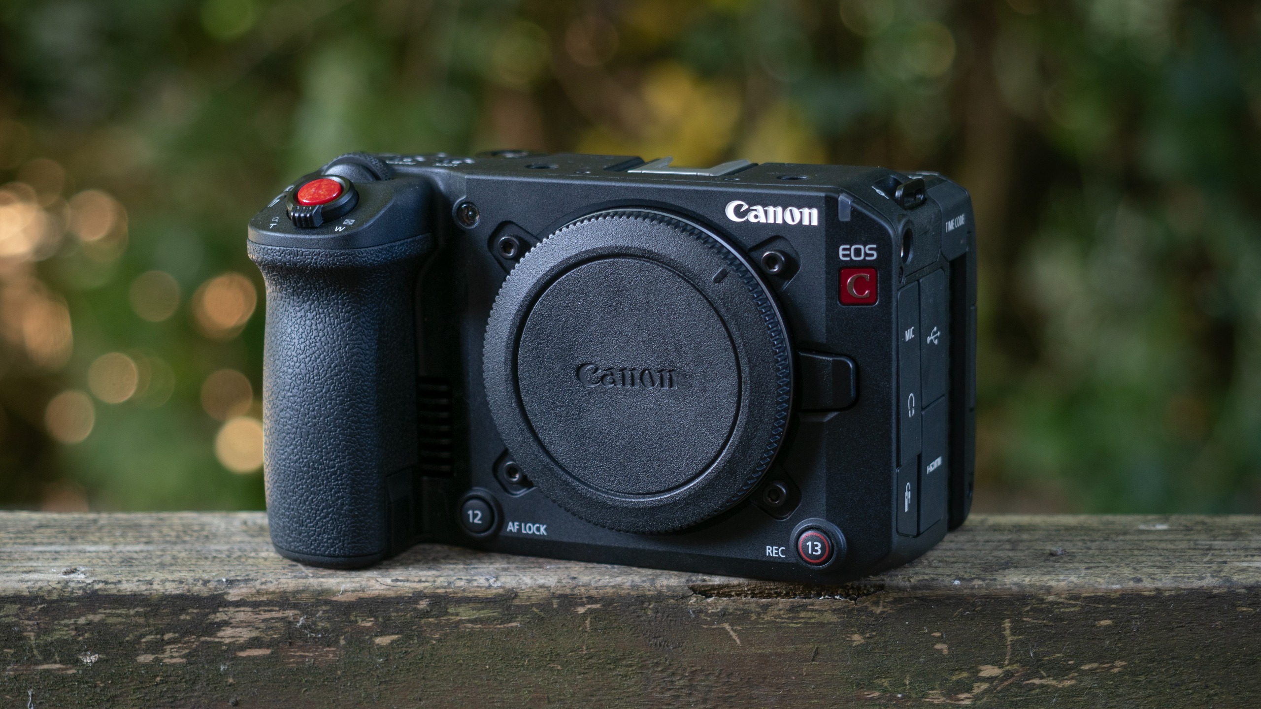 Canon EOS C50 sitting on a wooden surface outdoors