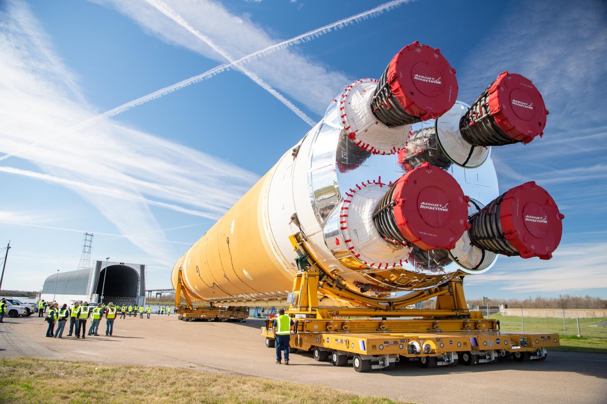 The first completed core stage of NASA’s Space Launch System rocket is guided toward the agency’s Pegasus barge on Jan. 8, 2020, ahead of its forthcoming journey to NASA’s Stennis Space Center in Mississippi. Teams rolled the core out from NASA’s Michoud Assembly Facility in New Orleans to the barge in preparation for the core stage “green run” test series.