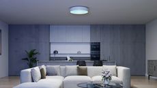 a kitchen with a false round skylight in the ceiling