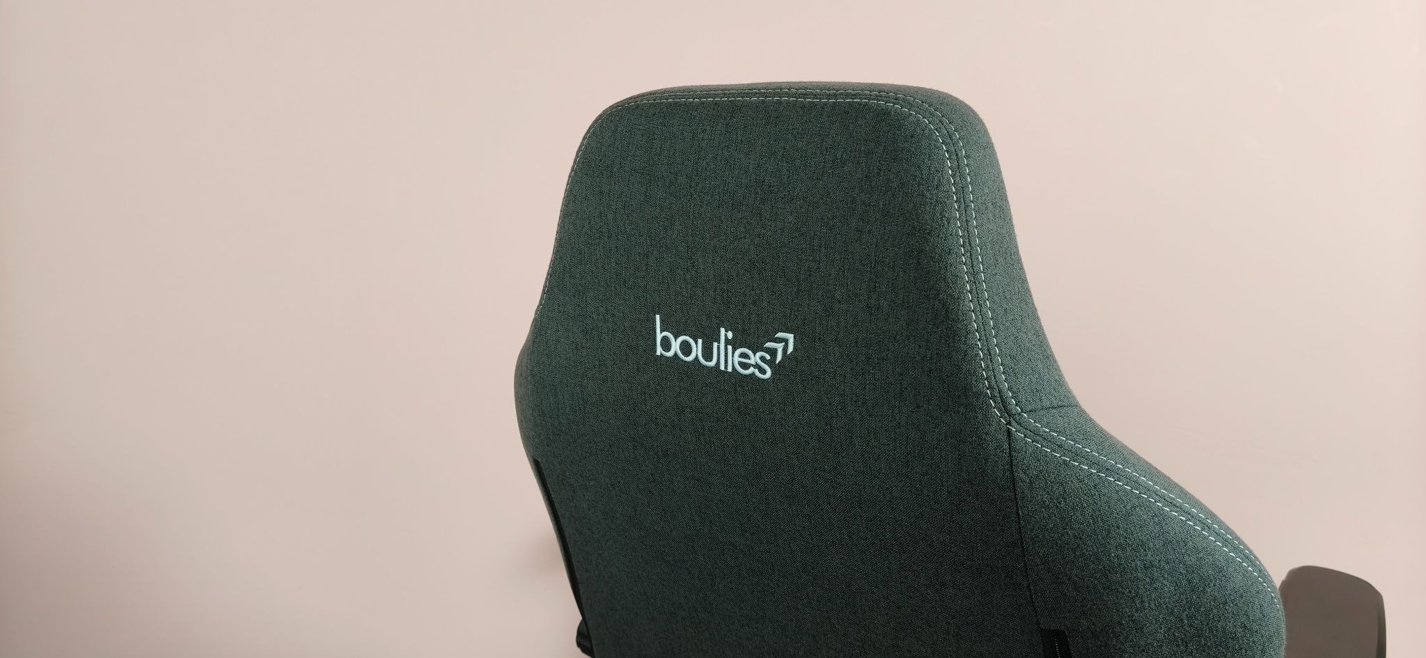 Close-up of back of headrests on Boulies Master Rex (2026), with pink wall in background