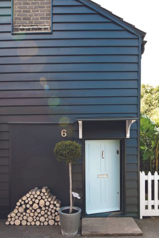 Black painted house with white front door