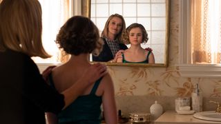 A still from the TV show little fires everywhere in which Reese Witherspoon stands in front of a mirror.