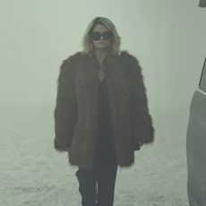 Selena Gomez in Emilia Perez wearing a YSL fur coat walking in the snow in Switzerland