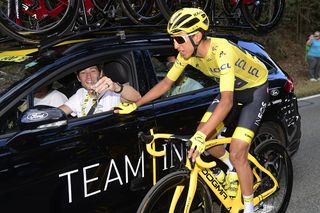 Egan Bernal in yellow surrounded by Team Ineos stage 21 at the Tour de France