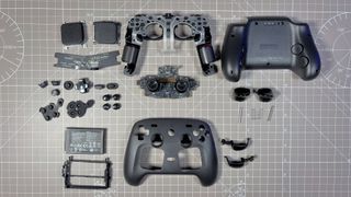 The Steam Controller on a desk during a teardown, with various parts removed.