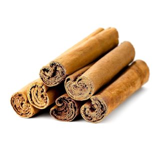 six sticks of cinnamon sitting on top of each other on a white background