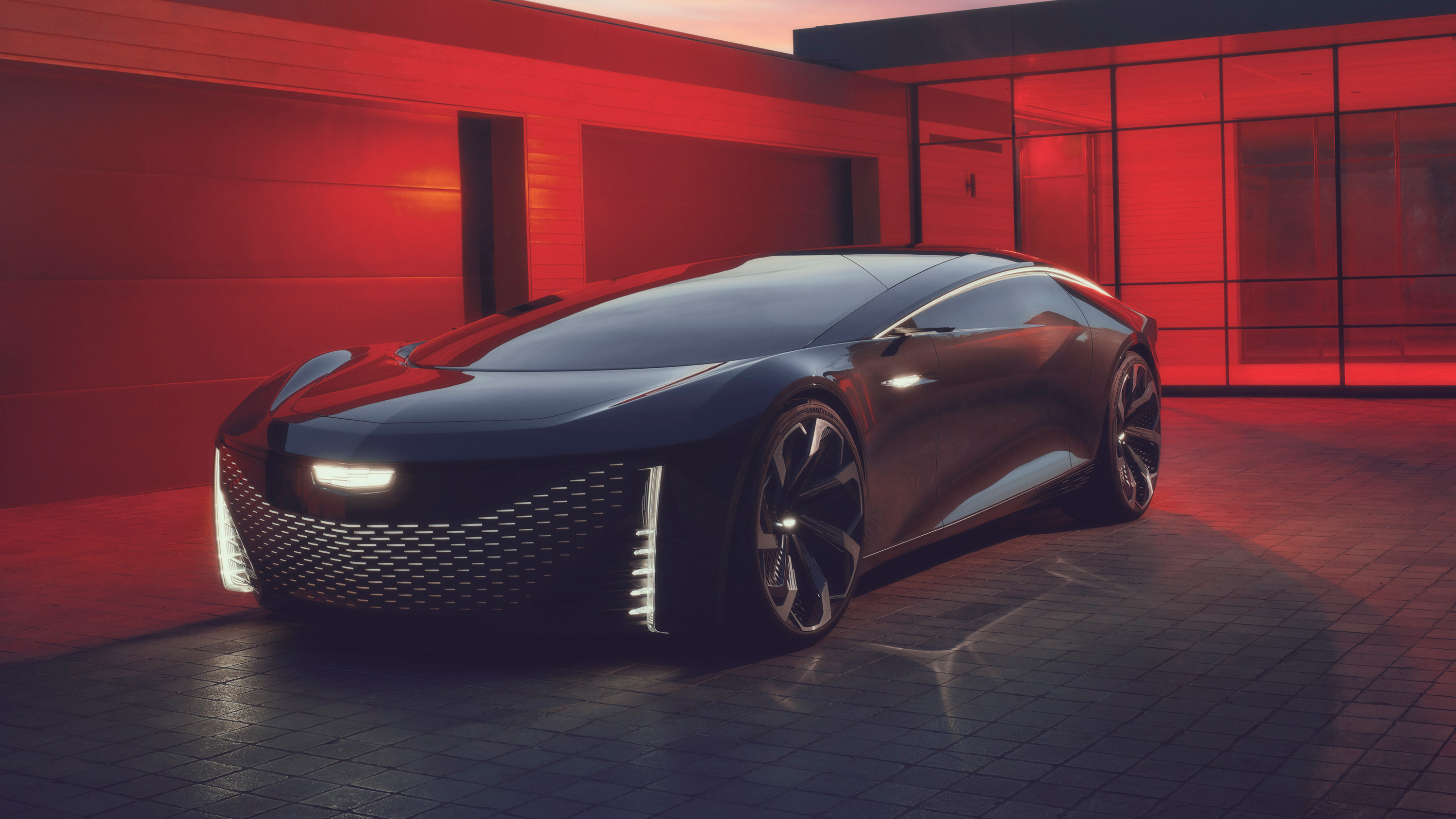 Cadillac InnerSpace concept parked outside modern home in red lighting