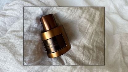 Tom Ford Oud Minerale fragrance shot on a linen background