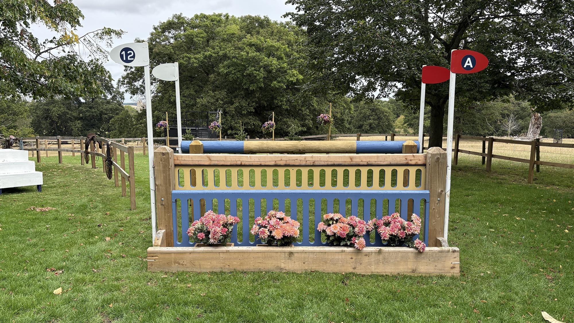 Decorated blue and wooden oxer fence on the Burghley cross-country course 2026