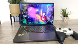 Asus ROG Zephyrus G14 laptop playing a game while on a desk