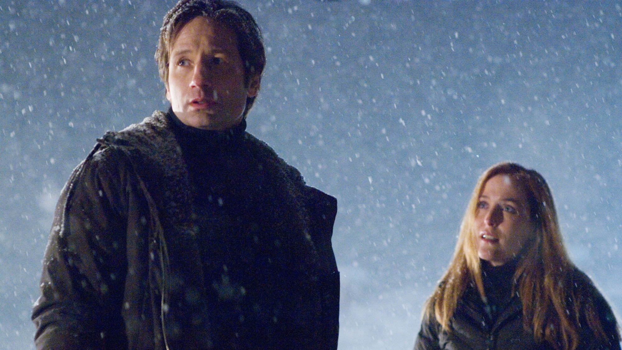 a man in winter clothing looks confused outside in the snow