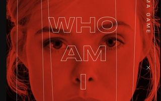 close up of actress Elle Fanning's face in red cast with text "Who am I?" overlaid.