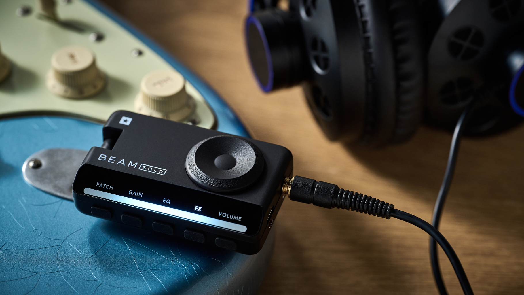 A Blackstar Beam Solo headphone amp for guitar plugged into a Stratocaster with a pair of headphones