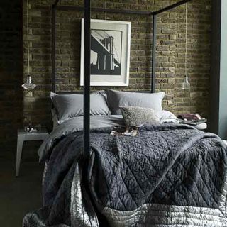 rustic loft style bedroom with four poster bed