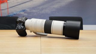 Canon RF 200-800mm f/6.3-9 IS USM lens on a Canon EOS R5 camera on a wooden table