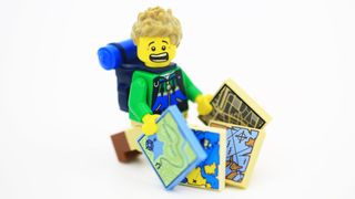 lego mini-figure panicking with a lot of maps