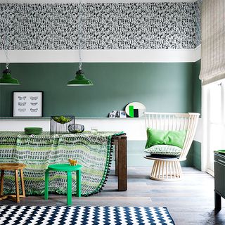 green dining room with printed tablecloth