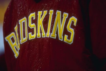 A fan wearing a Redskins team jersey is accusing a White House official of beating him up. 
