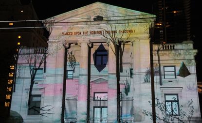 an art projection by Rebecca Chaperon on the exterior of a building 
