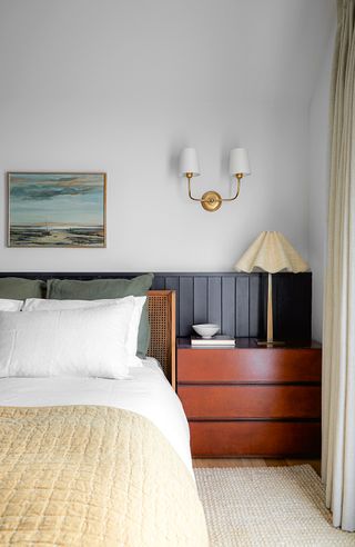 bedroom with navy wood panelling as the headboard