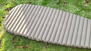 Alpkit Whisper sleeping mat on grass