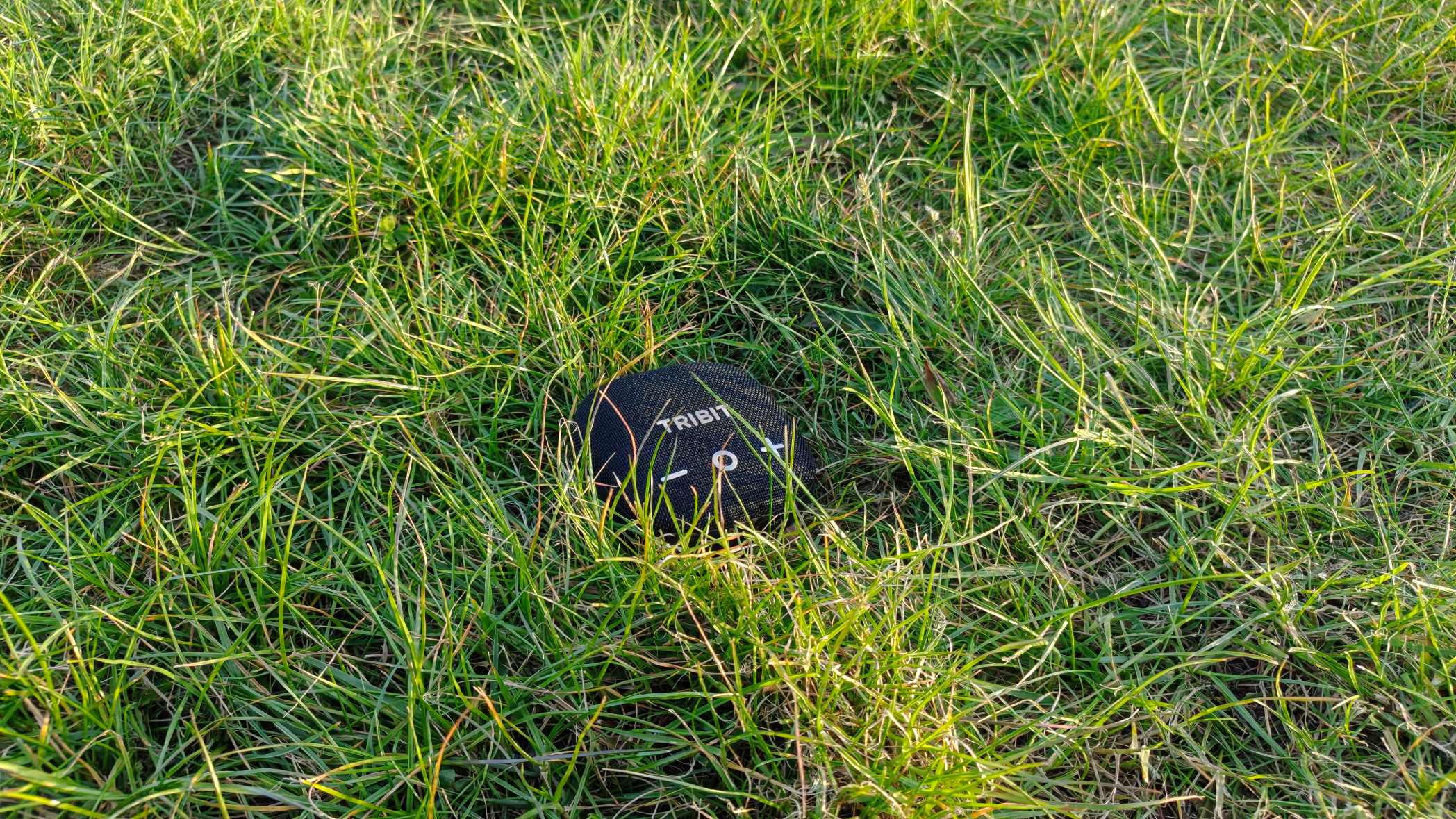 The Tribit Stormbox Micro 3 on a grassy backdrop.