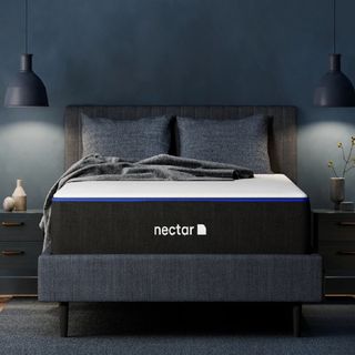 A Nectar mattress on a bed with hanging bedside lamps