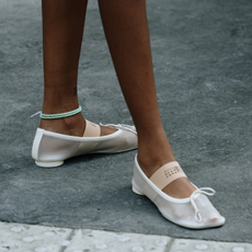 woman wearing white mesh flats in Paris. 