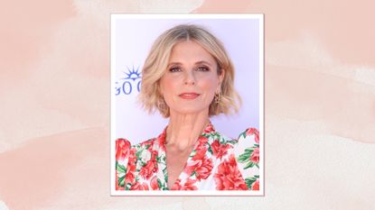 Image of Emilia Fox at 2025 BAFTAs with a short curled blonde bob and wearing a coral floral dress, on a pink watercolour background
