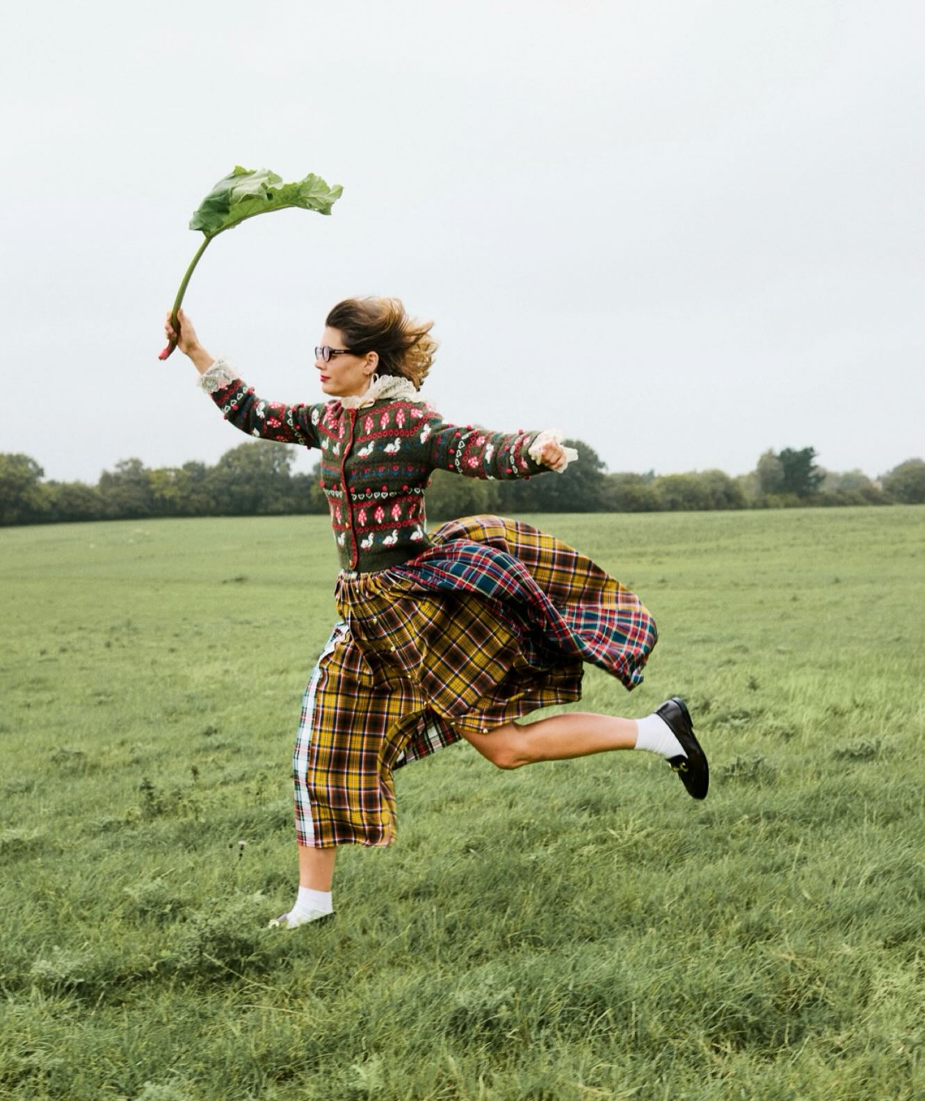 how to wear a kilt in 2026: sarah corbett winder wears a knitted cardigan, kilt skirt and leather loafers