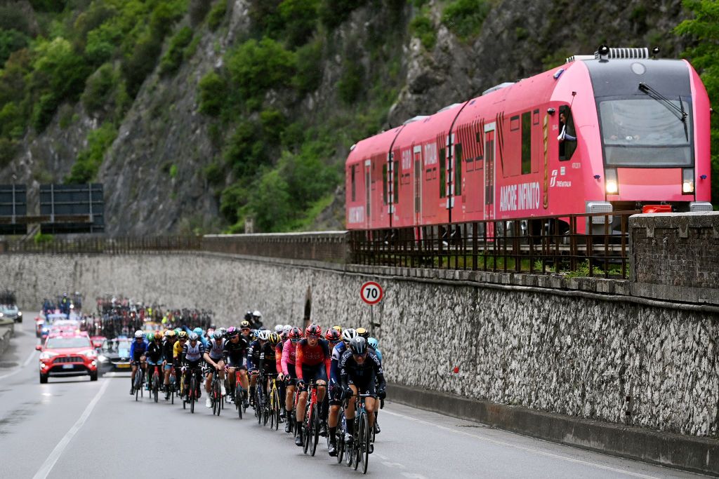 VIAREGGIO ITALY MAY 16 LR Geraint Thomas of The United Kingdom Pink Leader Jersey Thymen Arensman of The Netherlands and Team INEOS Grenadiers Louis Vervaeke of Belgium and Team Soudal Quick Step and Jonas Iversby Hvideberg of Norway and Team DSM lead the peloton close a Pink Giro decorated train during the 106th Giro dItalia 2023 Stage 10 a 196km stage from Scandiano to Viareggio UCIWT on May 16 2023 in Viareggio Italy Photo by Tim de WaeleGetty Images