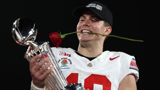 Will Howard (No. 18) of the Ohio State Buckeyes holds the Leishman Trophy after defeating the Oregon Ducks 41-21 in the Rose Bowl Game Presented by Prudential at Rose Bowl Stadium on January 01, 2025 in Pasadena, California.