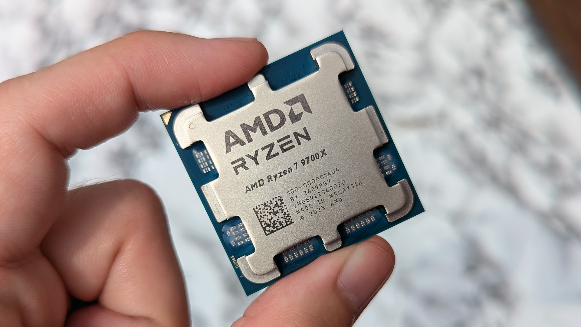 AMD Ryzen 7 9700X processor held in hand