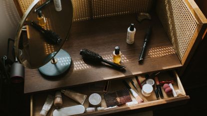 Make-up in the drawer of a wooden dressing table - make-up expiry dates